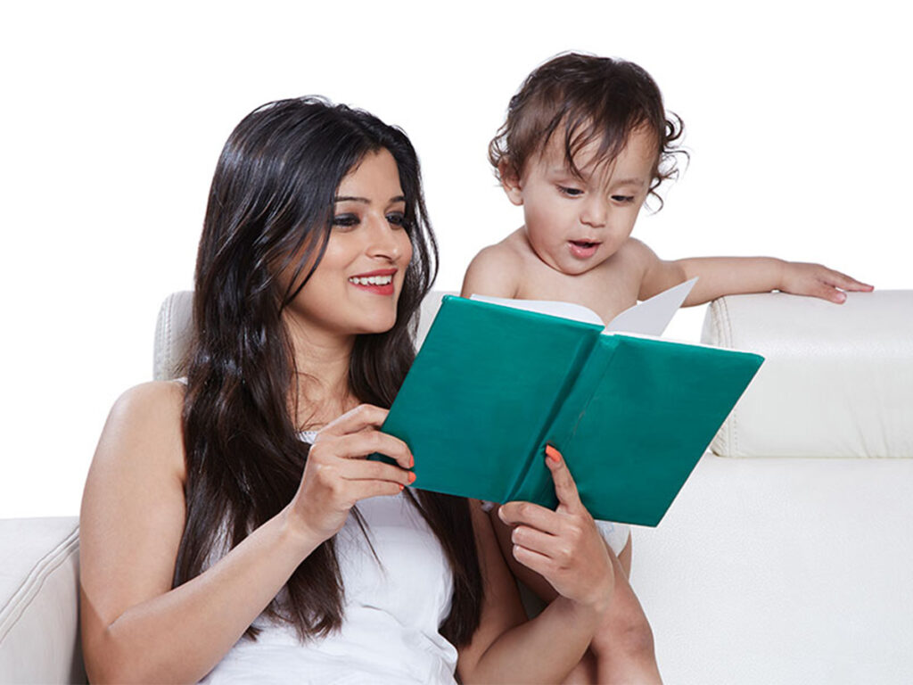 Mother Reading a Book to Her Baby on the Couch